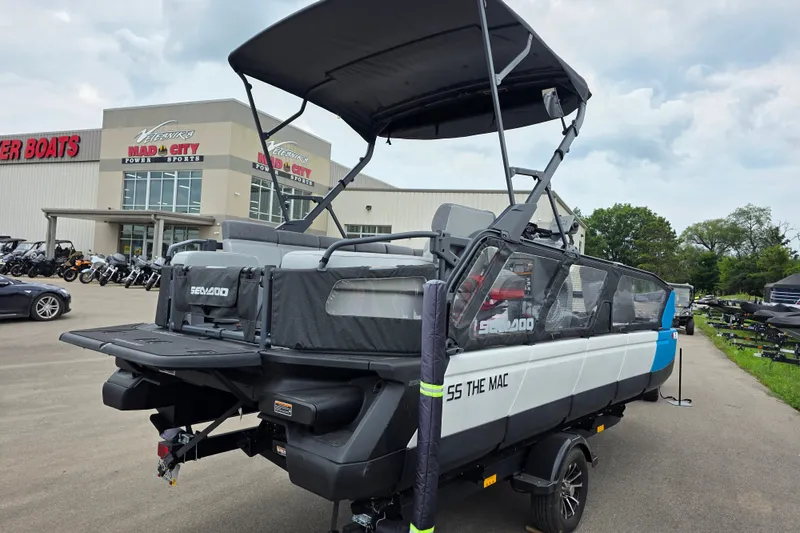 Slide: The Image of 2023 Sea-Doo Switch Sport 21 pontoon boat displayed at a dealership. - 3