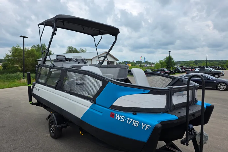 Slide: The Image of 2023 Sea-Doo Switch Sport 21 pontoon boat on trailer, parked outdoors. - 5