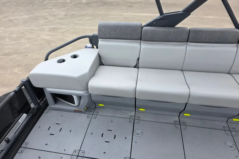 Slide: The Image of 2023 Sea-Doo Switch Sport 21 interior seating with cup holders and modular flooring. - 9