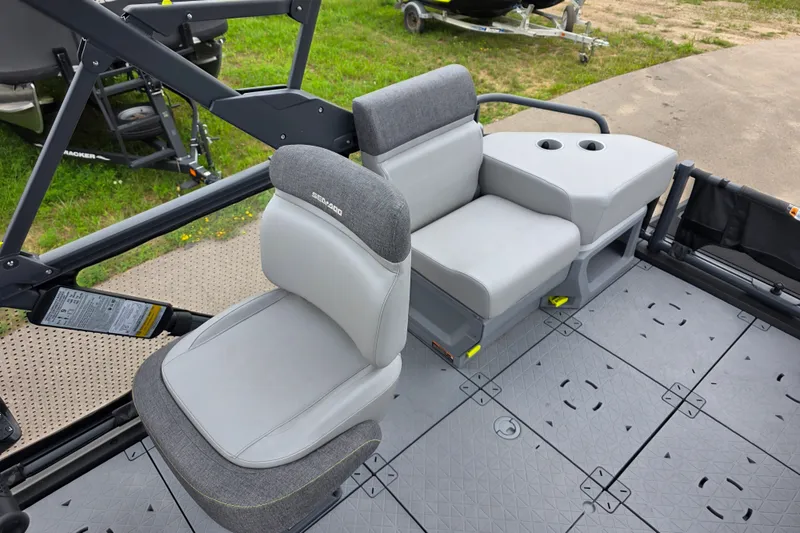 Slide: The Image of 2023 Sea-Doo Switch Sport 21 interior seating with gray upholstery and cup holders. - 8