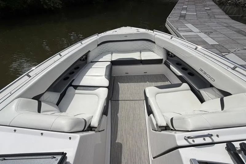 Slide: The Image of 2019 Regal 3300 Bowrider with spacious seating and elegant design on calm water. - 17