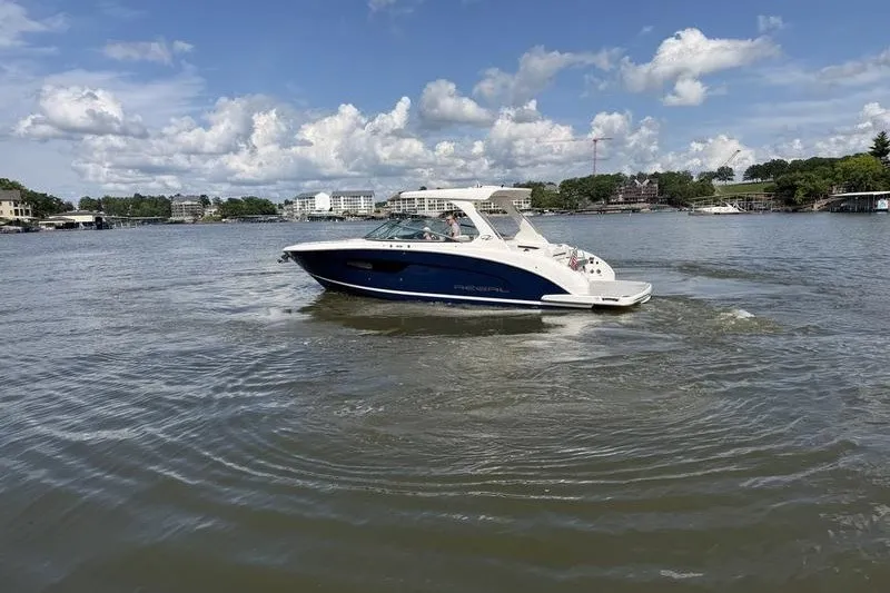 Slide: The Image of 2019 Regal 3300 Bowrider cruising on a lake under a partly cloudy sky. - 7
