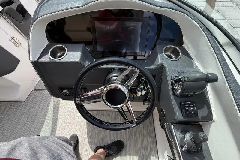 Slide: The Image of Cockpit of 2019 Regal 3300 Bowrider with steering wheel and control panel. - 12
