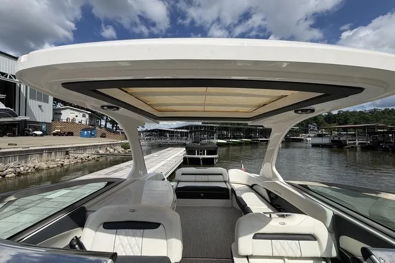 Slide: The Image of 2019 Regal 3300 Bowrider boat interior with spacious seating and open canopy. - 10