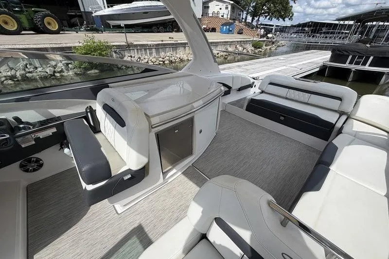 Slide: The Image of 2019 Regal 3300 Bowrider interior with sleek seating and modern design at a marina. - 9