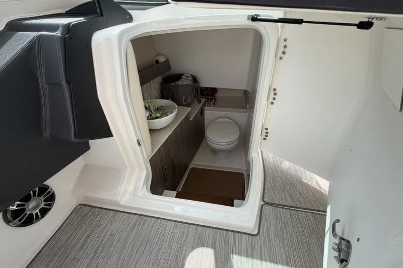 Slide: The Image of 2019 Regal 3300 Bowrider interior cabin with compact bathroom and modern amenities. - 18