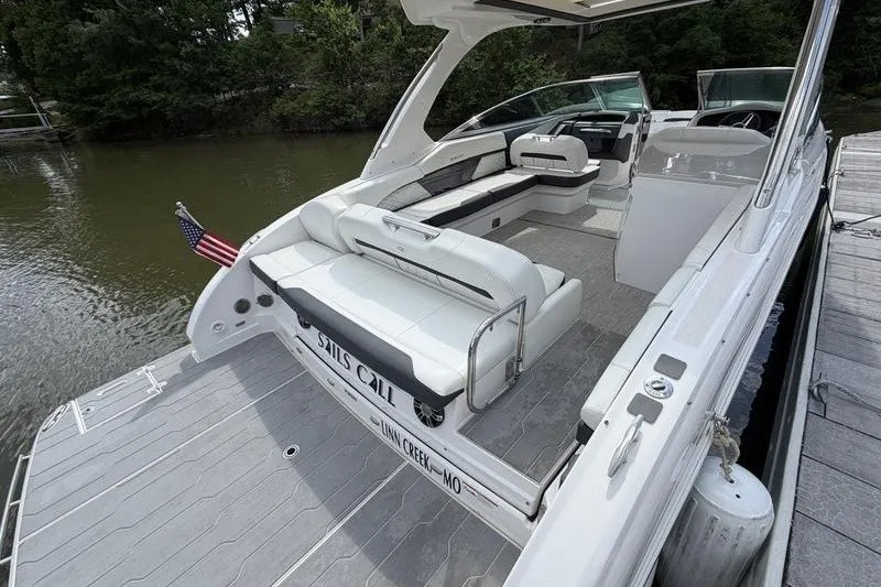 Slide: The Image of 2019 Regal 3300 Bowrider boat docked, featuring spacious seating and sleek design. - 23