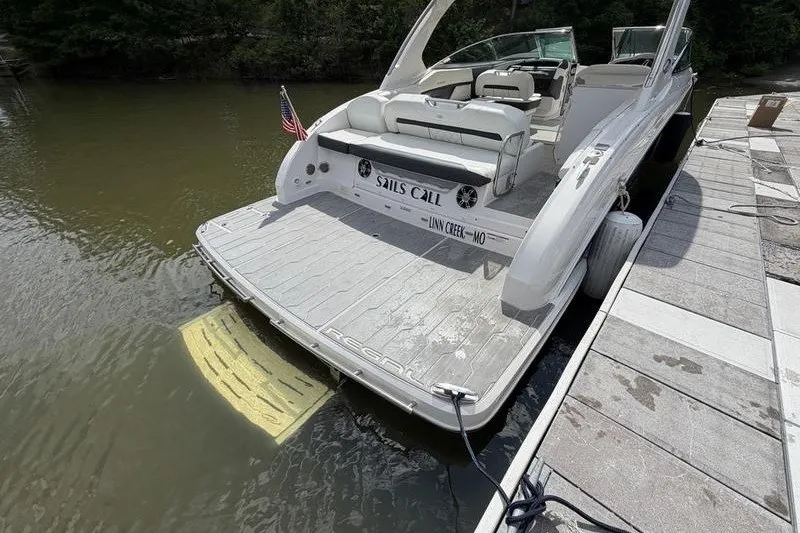 Slide: The Image of 2019 Regal 3300 Bowrider docked, featuring spacious seating and sleek design. - 25