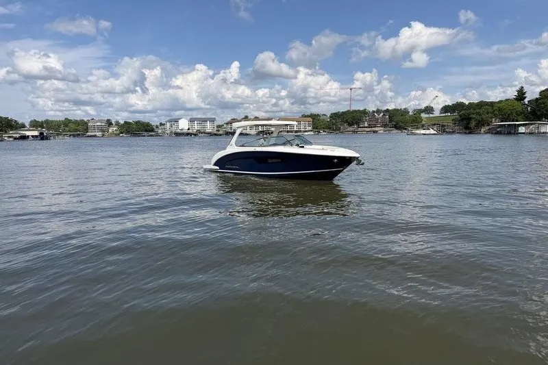 Slide: The Image of 2019 Regal 3300 Bowrider on a serene lake under a partly cloudy sky. - 3