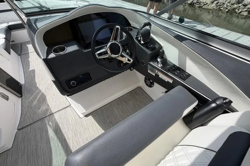 Slide: The Image of 2019 Regal 3300 Bowrider cockpit with modern steering and control panel. - 14