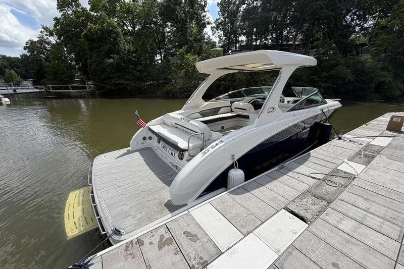 Slide: The Image of 2019 Regal 3300 Bowrider docked on a sunny day by a wooded shoreline. - 26
