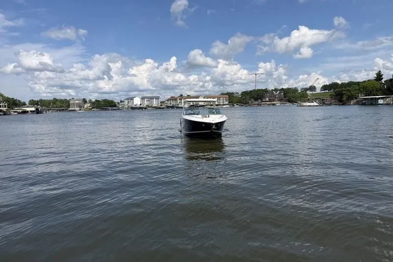 Slide: The Image of 2019 Regal 3300 Bowrider on a serene lake with cloudy sky backdrop. - 4