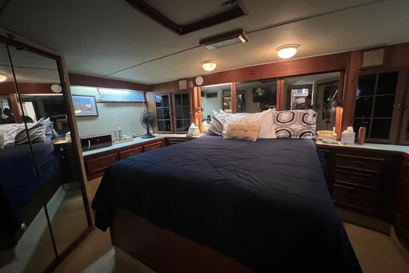 Slide: The Image of Luxurious bedroom interior of 1986 Chris Craft 47 Constellation yacht with elegant wood finishes. - 41
