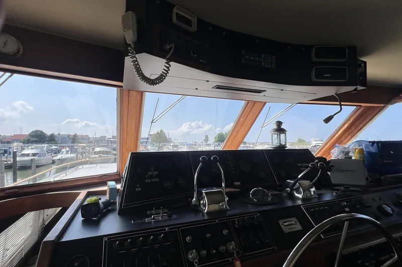 Slide: The Image of Interior view of 1986 Chris Craft 47 Constellation yacht cockpit with marina in background. - 19