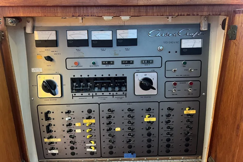 Slide: The Image of Control panel of a 1986 Chris Craft 47 Constellation yacht, featuring various switches and gauges. - 56