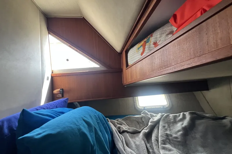 Slide: The Image of Cozy cabin interior of 1986 Chris Craft 47 Constellation with bunk beds and bedding. - 70