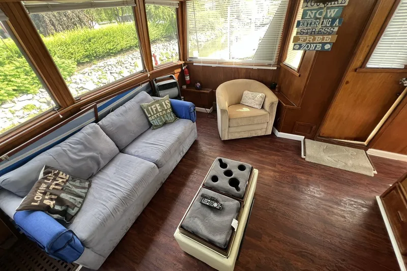 Slide: The Image of Cozy interior of 1986 Chris Craft 47 Constellation with sofa, armchair, and decor. - 81