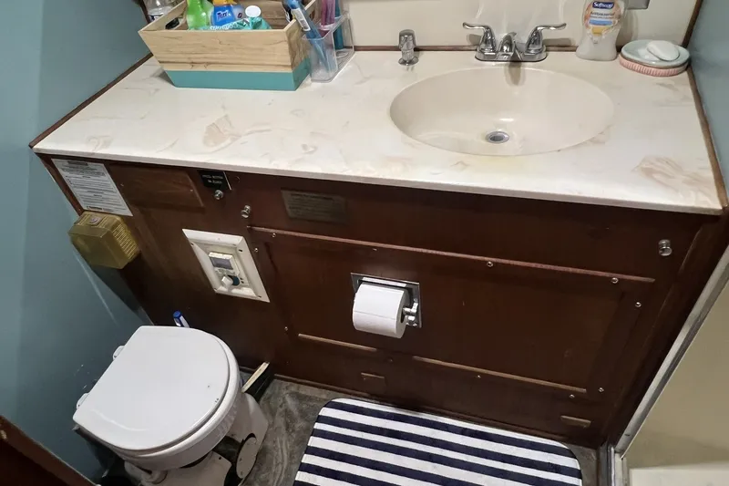 Slide: The Image of Bathroom interior of 1986 Chris Craft 47 Constellation yacht, featuring sink and toilet. - 47