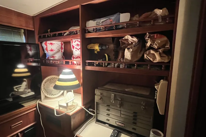 Slide: The Image of Interior of 1986 Chris Craft 47 Constellation with shelves, tools, and a lamp. - 54