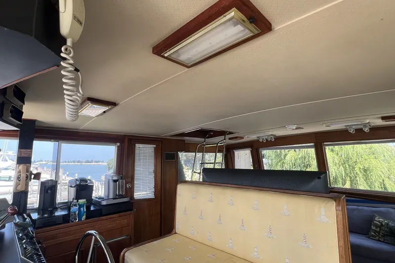 Slide: The Image of Interior of 1986 Chris Craft 47 Constellation yacht with scenic marina view. - 22