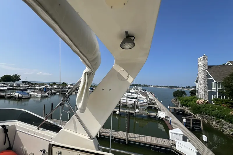 Slide: The Image of 1986 Chris Craft 47 Constellation yacht docked at a scenic marina. - 94