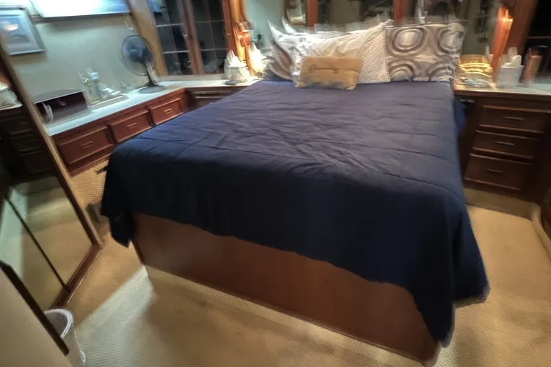 Slide: The Image of Luxurious bedroom interior of 1986 Chris Craft 47 Constellation yacht with elegant bedding. - 44