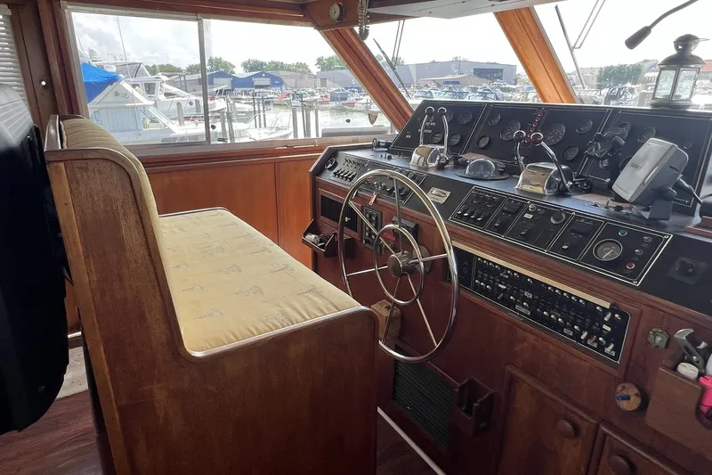 Slide: The Image of 1986 Chris Craft 47 Constellation yacht helm with vintage controls and wooden interior. - 28