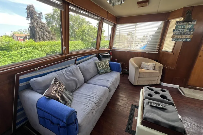 Slide: The Image of Interior of 1986 Chris Craft 47 Constellation yacht with cozy seating and large windows. - 25