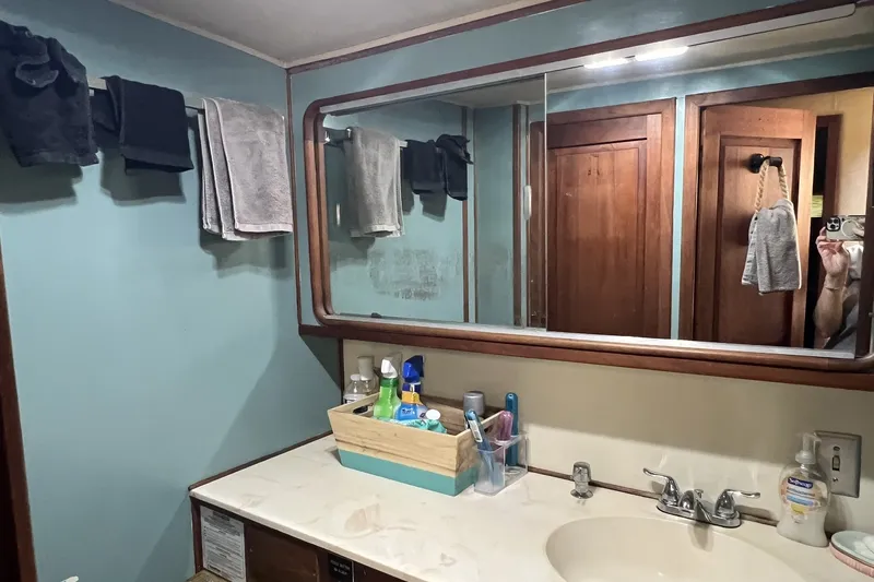 Slide: The Image of Bathroom interior of 1986 Chris Craft 47 Constellation yacht, featuring mirror and sink area. - 46