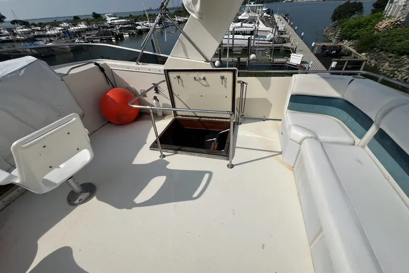 Slide: The Image of 1986 Chris Craft 47 Constellation yacht deck with seating and marina view. - 92