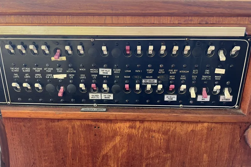 Slide: The Image of Control panel of a 1986 Chris Craft 47 Constellation yacht with various switches. - 73