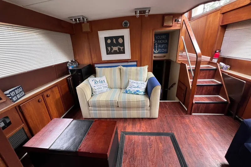 Slide: The Image of Interior of 1986 Chris-Craft 46 Constellation with cozy seating and nautical decor. - 89