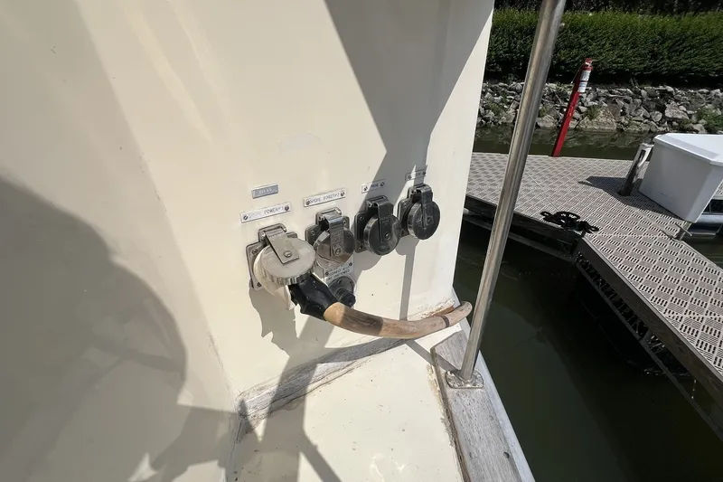 Slide: The Image of 1986 Chris Craft 47 Constellation boat power connections at dockside. - 17