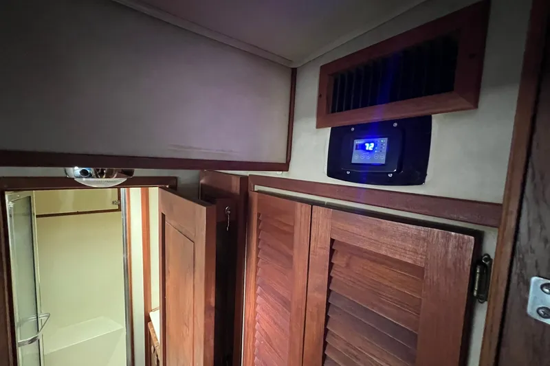 Slide: The Image of Interior of 1986 Chris-Craft 46 Constellation with wooden cabinetry and digital control panel. - 90