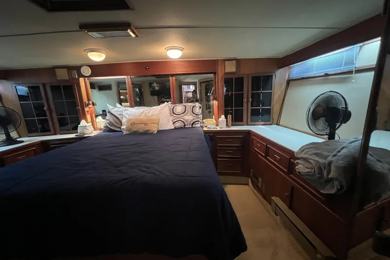 Slide: The Image of Luxurious cabin interior of 1986 Chris Craft 47 Constellation yacht with cozy bedding. - 42