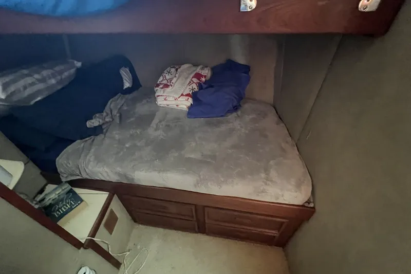 Slide: The Image of Cozy cabin bed in 1986 Chris Craft 47 Constellation yacht, with pillows and blankets. - 66
