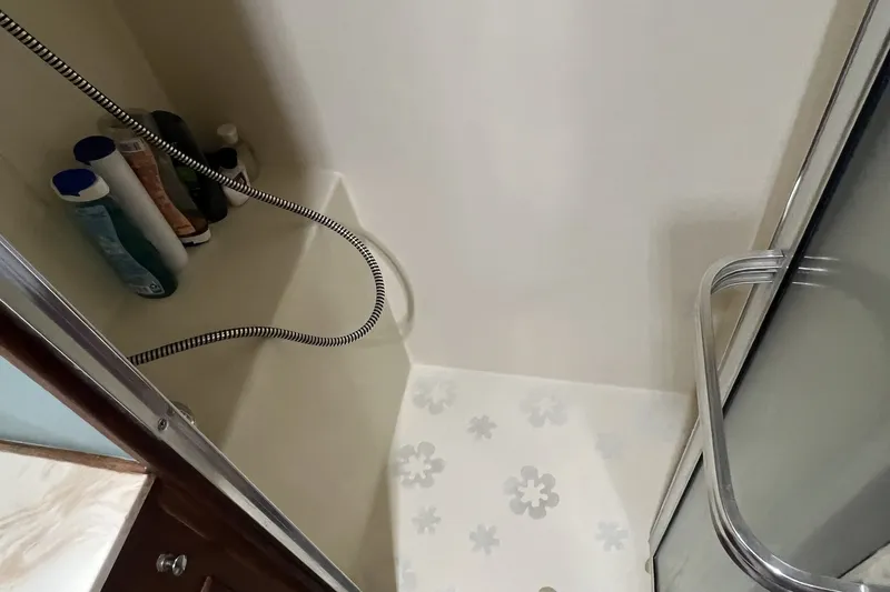 Slide: The Image of Shower area in 1986 Chris Craft 47 Constellation yacht with toiletries and sliding door. - 48