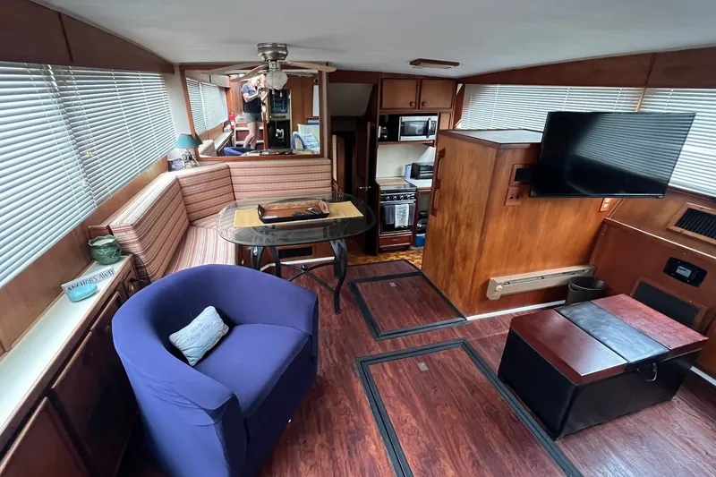 Slide: The Image of Interior of 1986 Chris-Craft 46 Constellation yacht with cozy seating and modern amenities. - 87