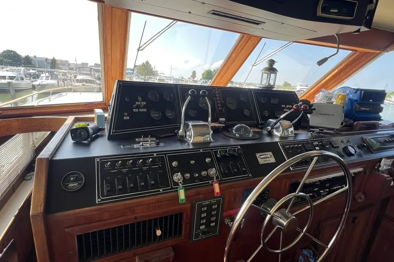 Slide: The Image of Helm of 1986 Chris Craft 47 Constellation yacht with navigation instruments and steering wheel. - 18