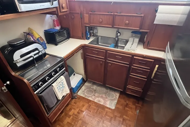 Slide: The Image of 1986 Chris Craft 47 Constellation kitchen with wooden cabinets and modern appliances. - 32