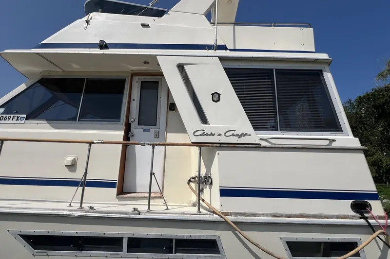 Slide: The Image of 1986 Chris Craft 47 Constellation yacht with white exterior and blue accents. - 5