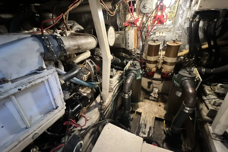 Slide: The Image of Engine room of a 1986 Chris Craft 47 Constellation yacht, showcasing mechanical components. - 98