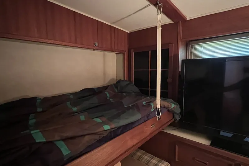 Slide: The Image of Cozy cabin interior of 1986 Chris Craft 47 Constellation with bed and TV. - 55