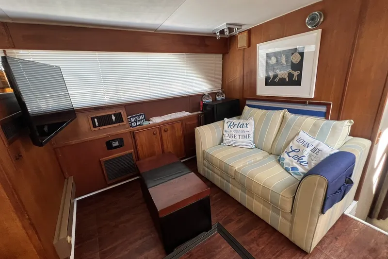 Slide: The Image of Cozy interior of 1986 Chris Craft 47 Constellation with striped sofa and nautical decor. - 40