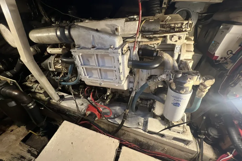 Slide: The Image of Engine room of a 1986 Chris Craft 47 Constellation yacht, showcasing mechanical components. - 101