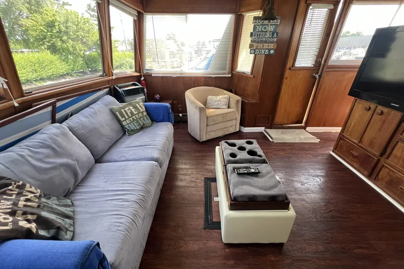 Slide: The Image of Interior of 1986 Chris Craft 47 Constellation yacht with cozy seating and decor. - 26