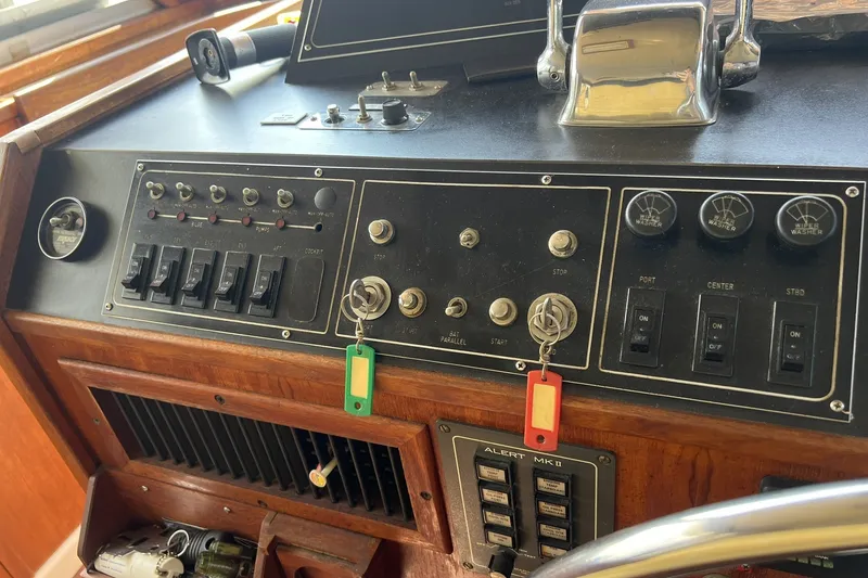 Slide: The Image of Control panel of a 1986 Chris Craft 47 Constellation boat with switches and keys. - 75