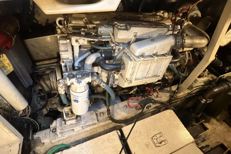 Slide: The Image of Engine room of a 1986 Chris Craft 47 Constellation yacht, showcasing mechanical components. - 96