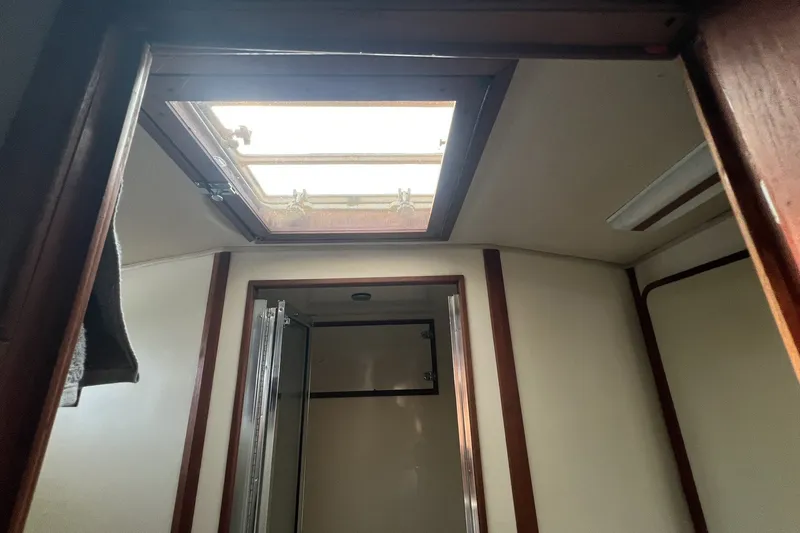 Slide: The Image of Interior view of 1986 Chris Craft 47 Constellation yacht with skylight and wooden trim. - 63