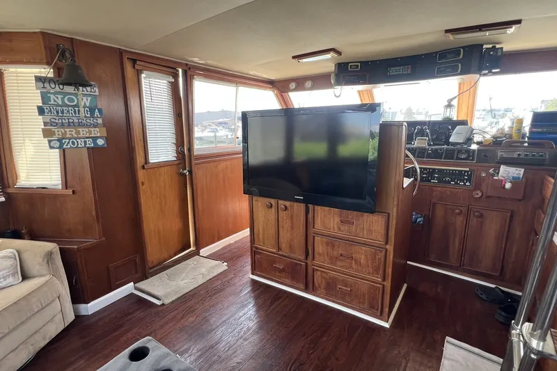 Slide: The Image of Interior of 1986 Chris Craft 47 Constellation yacht with wood paneling and modern amenities. - 24